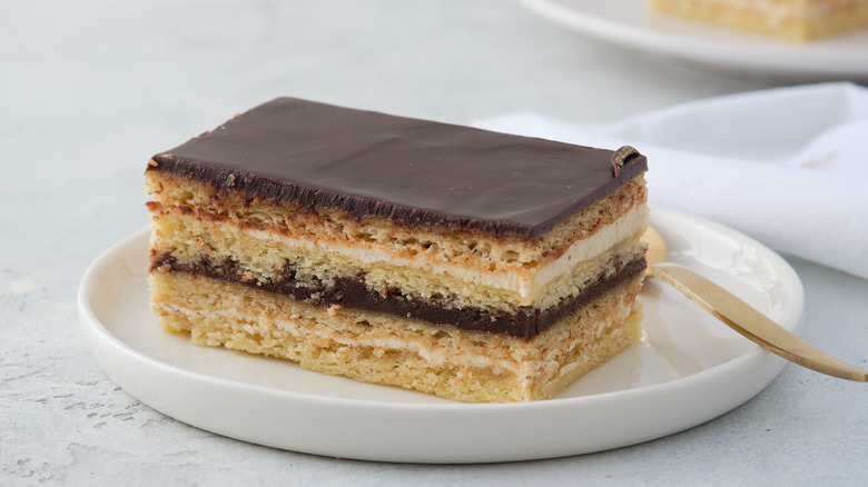 Slice of French opera cake on white plate