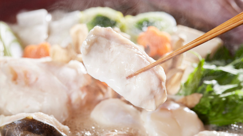 fugu held with chopsticks