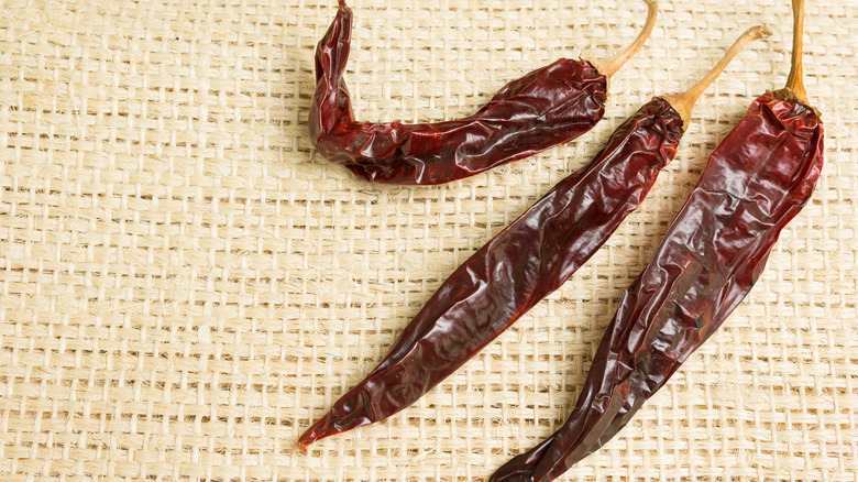 Dried guajillo chiles on burlap background