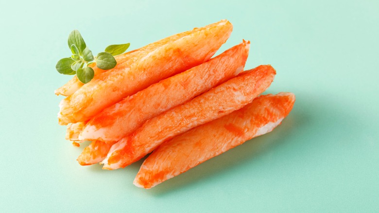 Crab sticks on green background