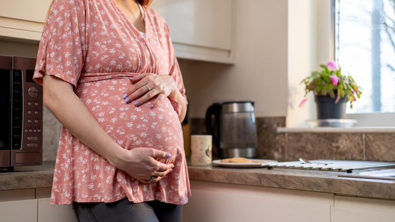 Pregnant person in kitchen 