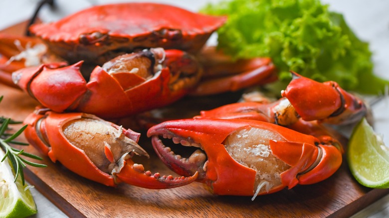 Crab claws on wooden board