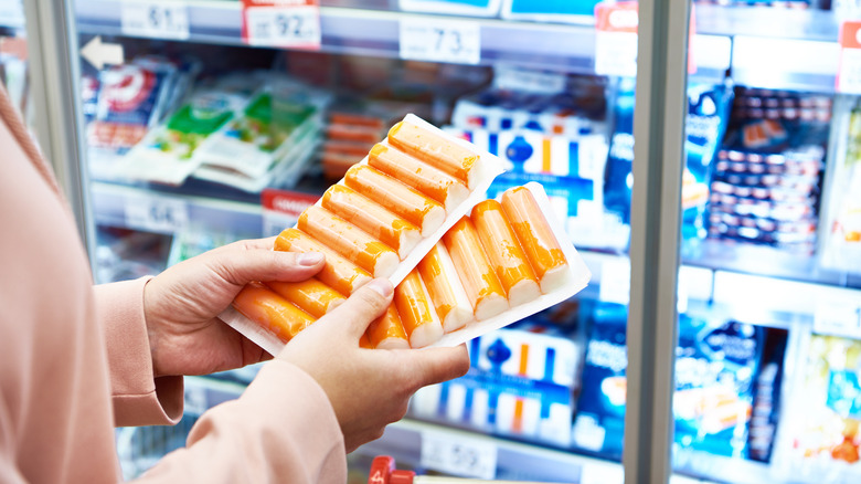 surimi sticks in customer's hands 