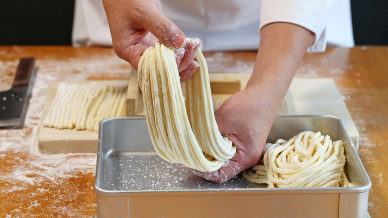 Chef making homemade udon noodles