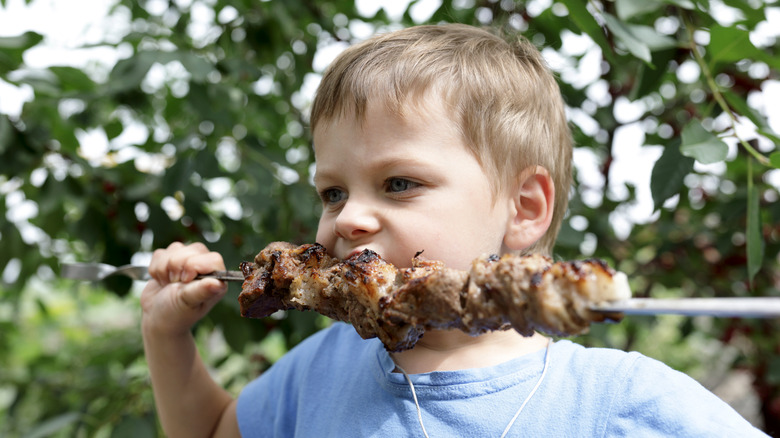 Boy eating a kebab