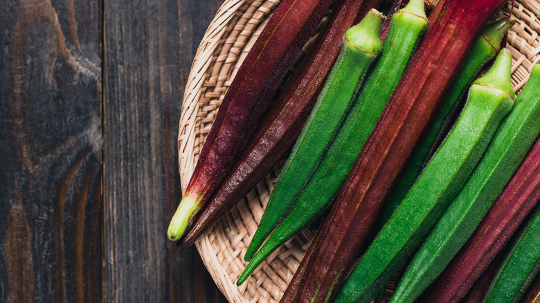 Red and green okra in basket