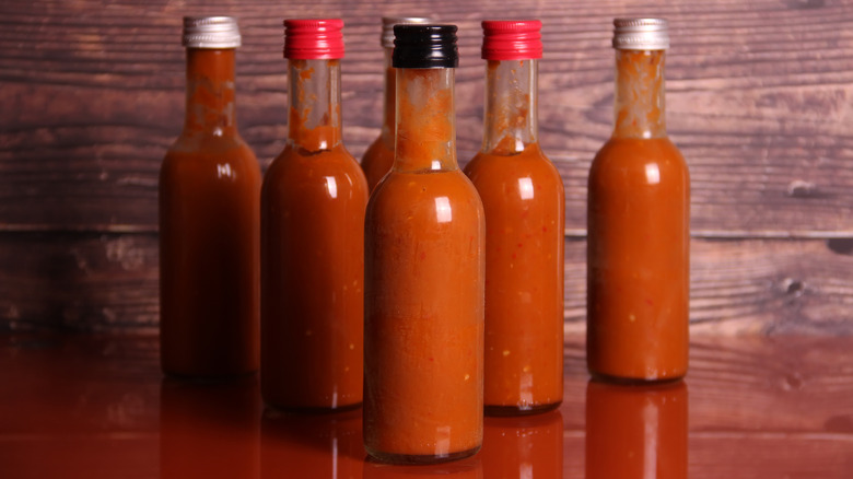 Hot sauce bottles on table