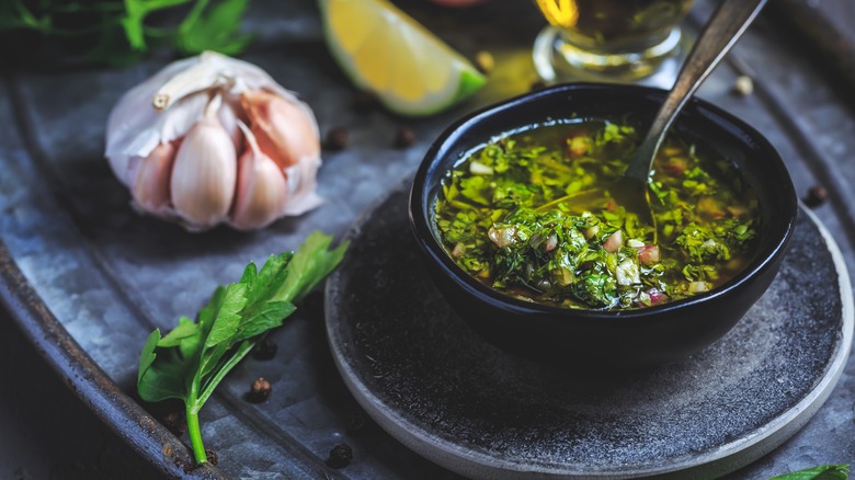 bowl filled with chimichurri next to ingredients