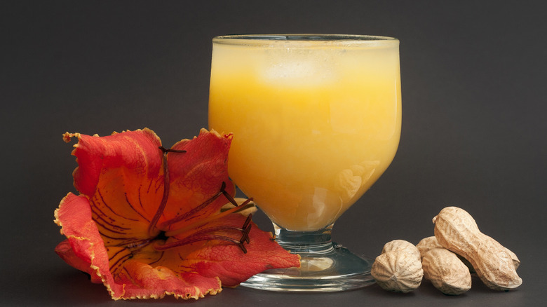 Glass of poncha with flower and peanuts