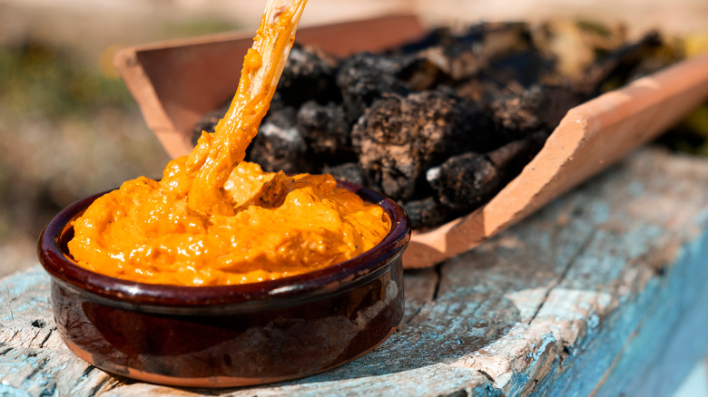 Grilled onions dipped in romesco