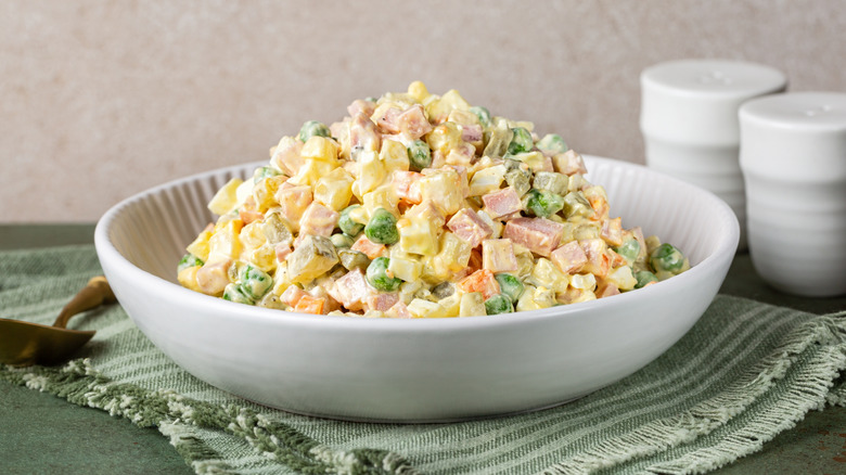 Russian egg salad, piled high in white bowl