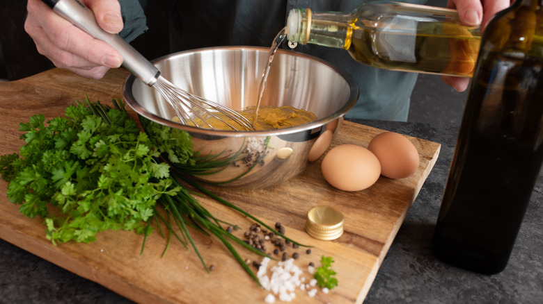 Adding oil to sauce gribiche