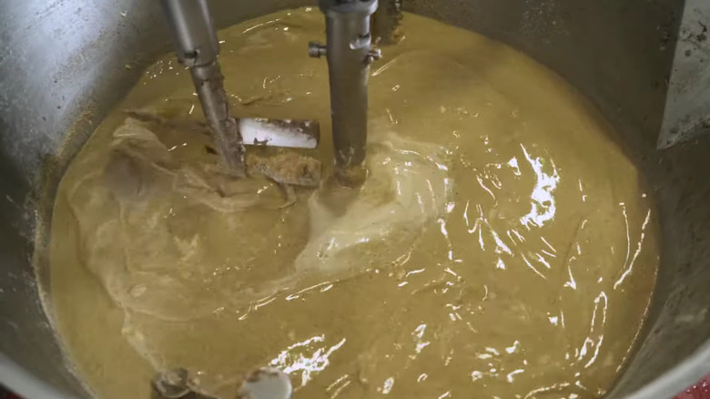 Scrapple being mixed and cooked by machinery