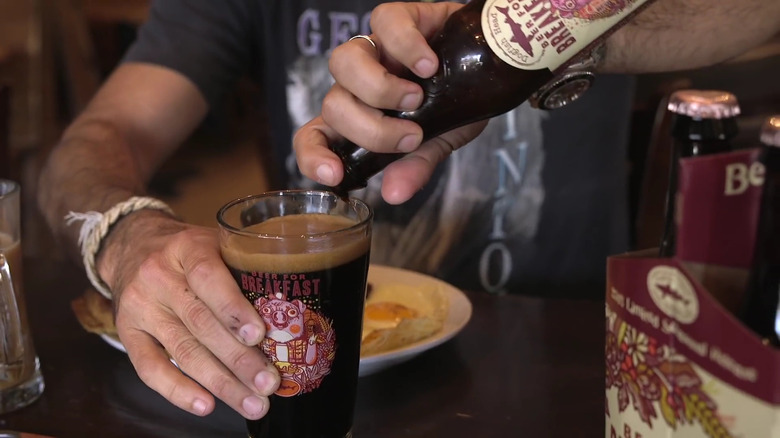 Man pouring Dogfish Head Beer for Breakfast