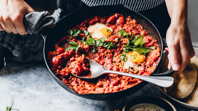 Holding a pan of shakshuka