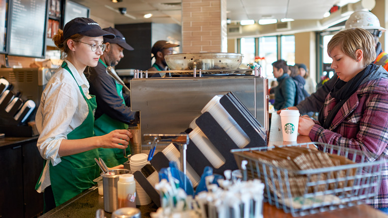 Starbucks baristas and customer