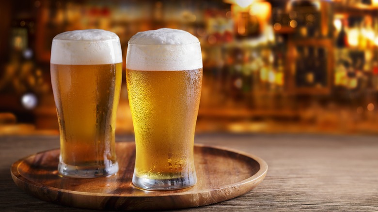 two glasses of beer on a tray