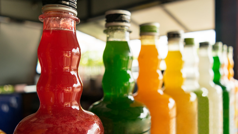 row of different coloured syrup bottles