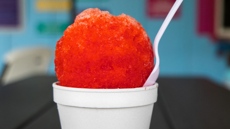 Red snow cone in a styrofoam cup.