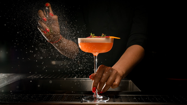 Person holding a cocktail