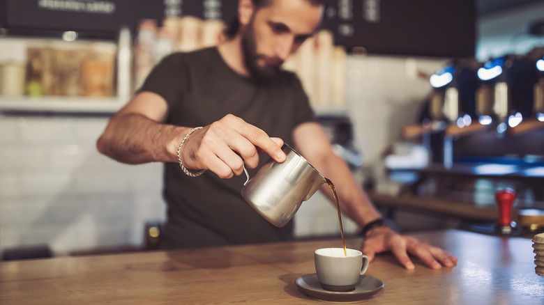 Barista pouring coffee