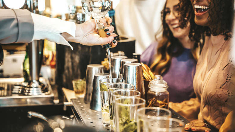 Bartender pouring drinks for happy customers