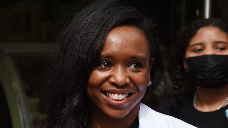 Dr. Maya Warren smiling in lab coat