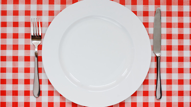 place setting on red checkered tablecloth 