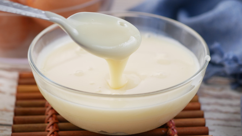 A glass bowl of condensed milk