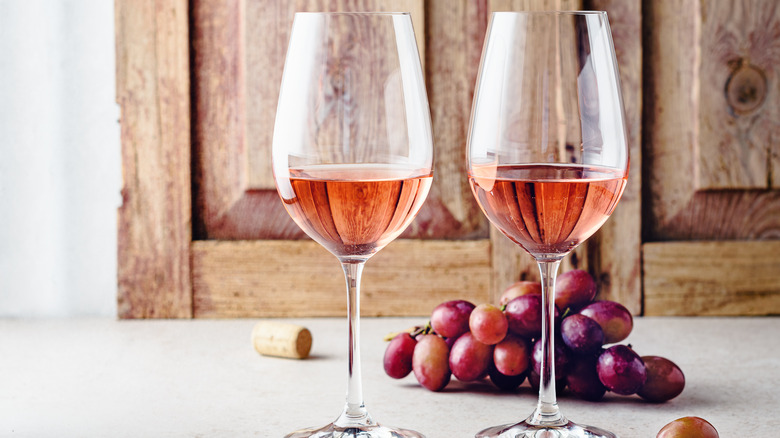 two glasses of rose with red grapes