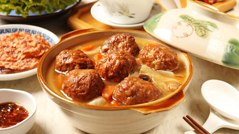 Lion's head meatballs in a serving dish 