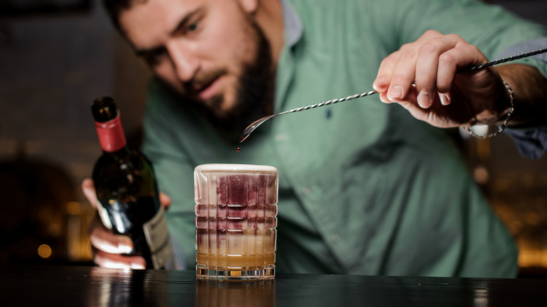 Bartender mixing New York Sour