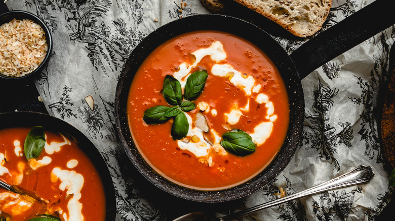 tomato soup in bowls topped with cream