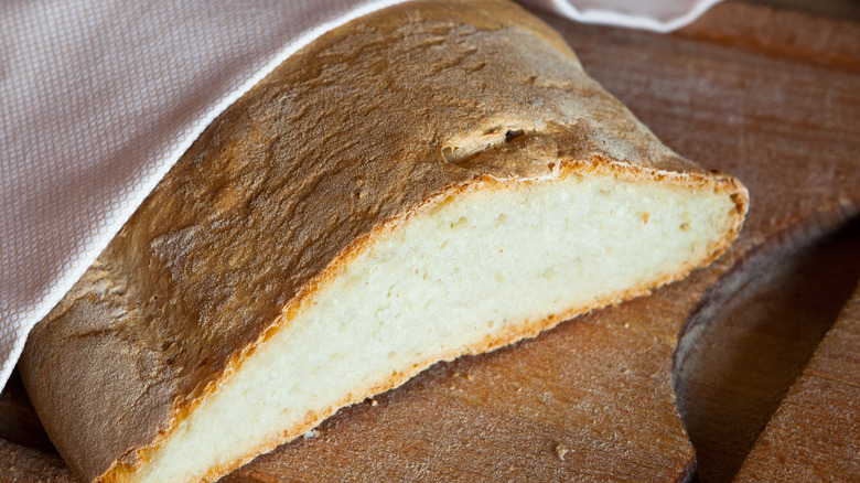 Sliced tuscan bread under towel 