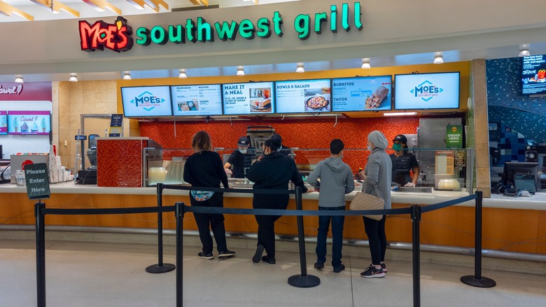 Customers ordering at Moe's counter