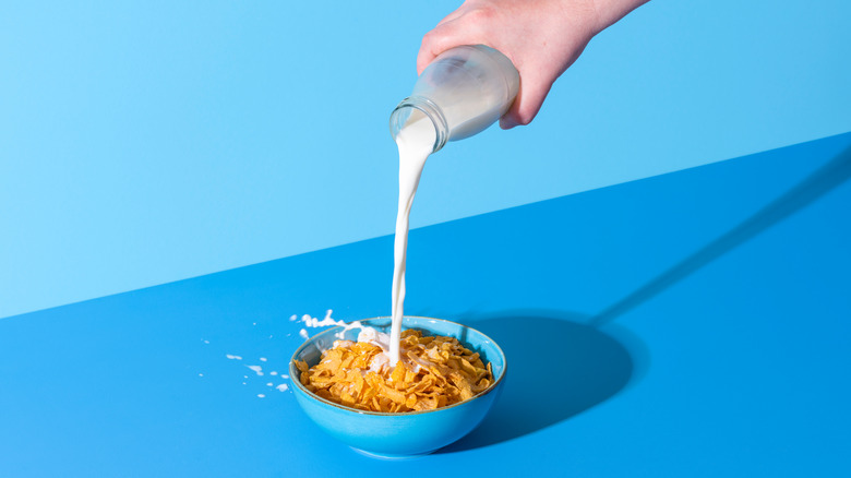 Milk pouring into cereal bowl