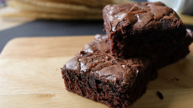 Brownies stacked on wooden platter