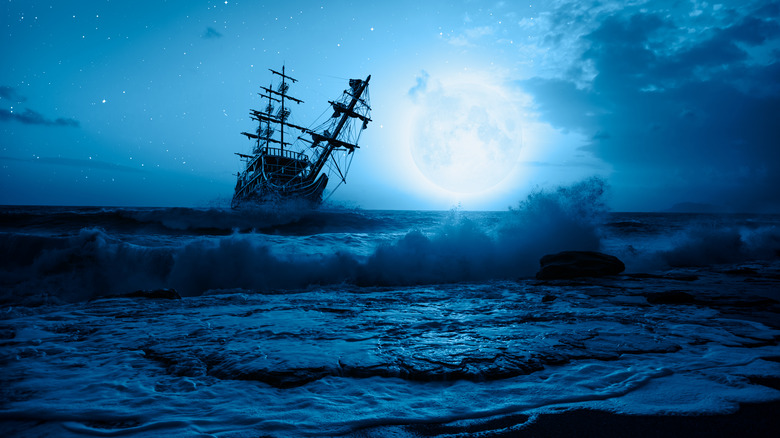 Ghost ship sailing under moonlight
