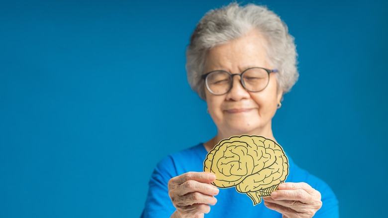 woman holding paper brain