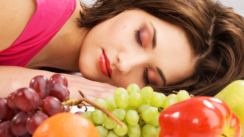 Sleeping woman with grapes