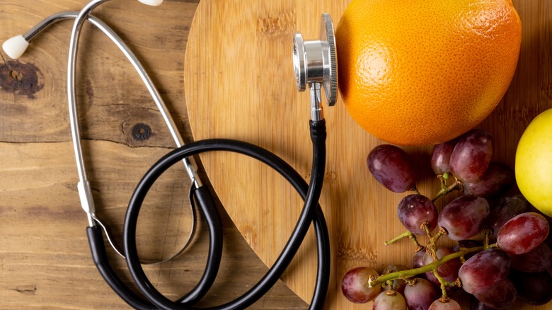 Stethoscope with orange and grapes