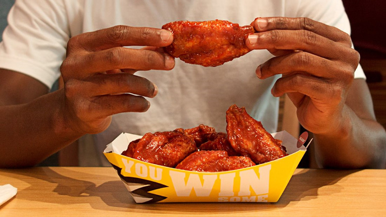 man holding Buffalo Wild Wings