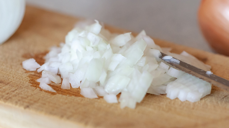 diced onion on wooden board