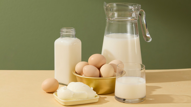 Milk, cream, eggs and butter on a countertop