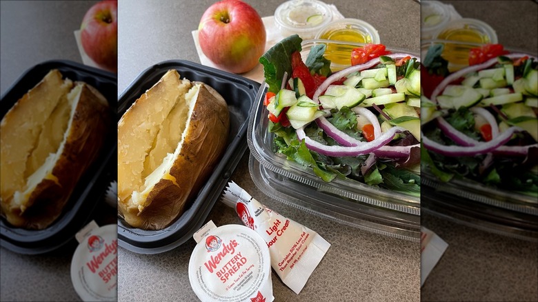 Wendy's baked potato and salad on table