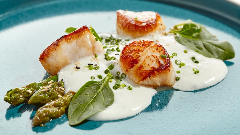 Scallops with greens and sauce