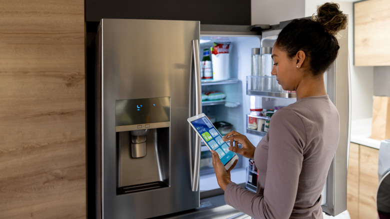 Person in front of open refrigerator