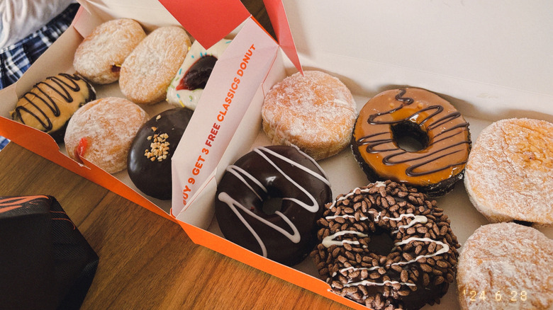 Two boxes of various fresh Dunkin' donuts