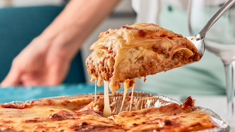 Person serving lasagna