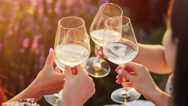 people toasting with white wine